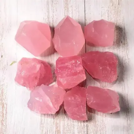 A close-up of ethically sourced Raw Rose Quartz Stones showcasing their soft, delicate pink hue and unique natural formations. Ideal for heart chakra healing, meditation practices, and adding a touch of bohemian elegance to home decor, these raw crystals radiate the energy of love and tranquility.