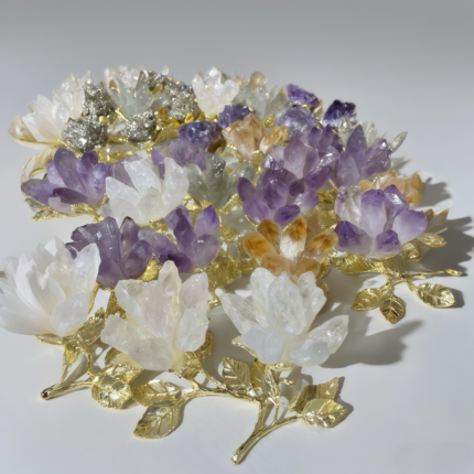 Amethyst crystal lotus flower with gold - plated stem and leaves held in a hand