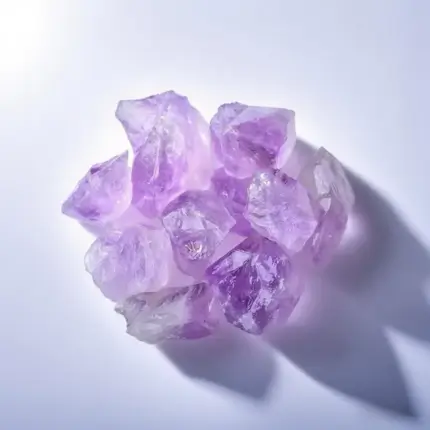 Close-up of a Natural Amethyst Raw Stone with Violet Dr.uzy Crystals on a Rustic Wooden Background