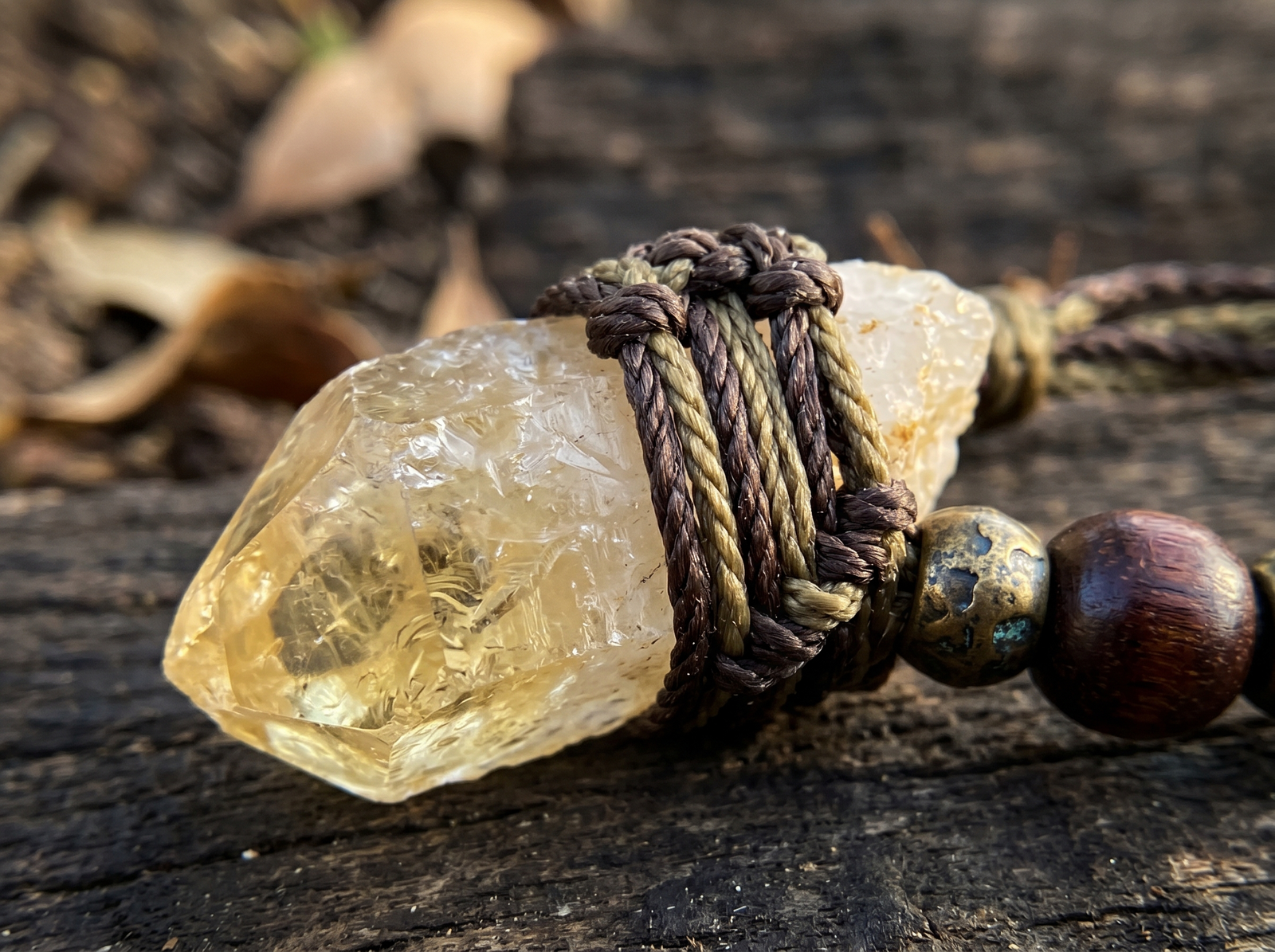 A masculine, minimalist authentic raw citrine macrame necklace with dark brown cord, bronze, and wooden beads for wealth.